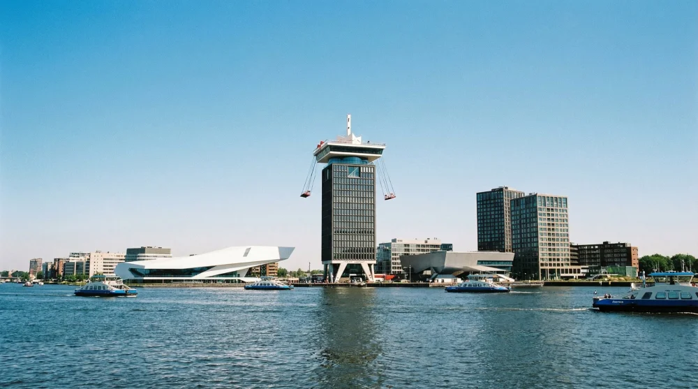 Exterior view of A'DAM Lookout tower rising above the IJ river in Amsterdam North