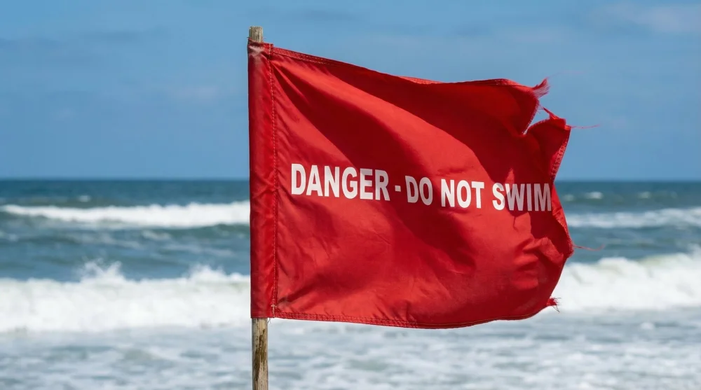 Red warning flag flying at a Destin beach lifeguard station