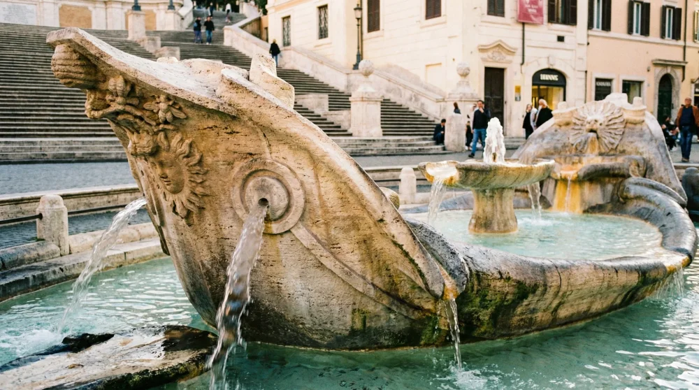 Close up of the Fontana della Barcaccia sinking boat fountain at the base of Piazza di Spagna