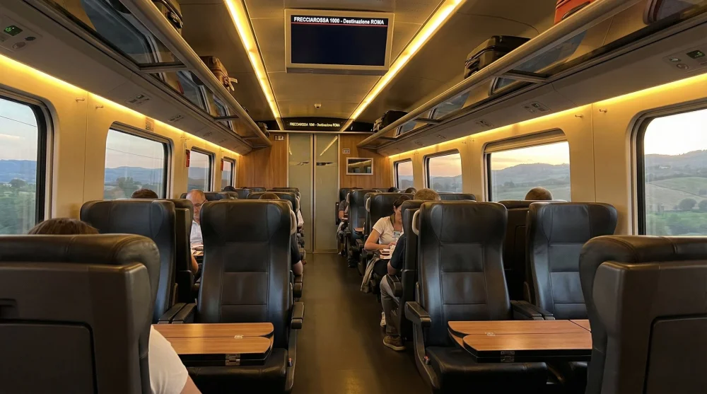 Interior of a Frecciarossa train showing comfortable standard class leather seats