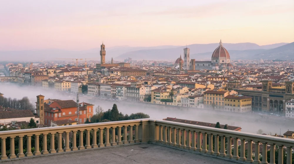 Misty sunrise view over the Arno River and Florence skyline without crowds