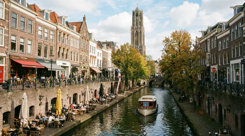 People dining at wharf cellars along the Oudegracht canal in Utrecht