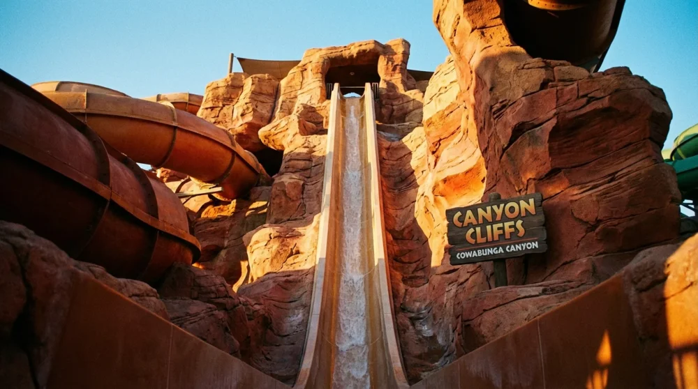 Steep vertical speed slide with desert canyon theme at Cowabunga Canyon Las Vegas
