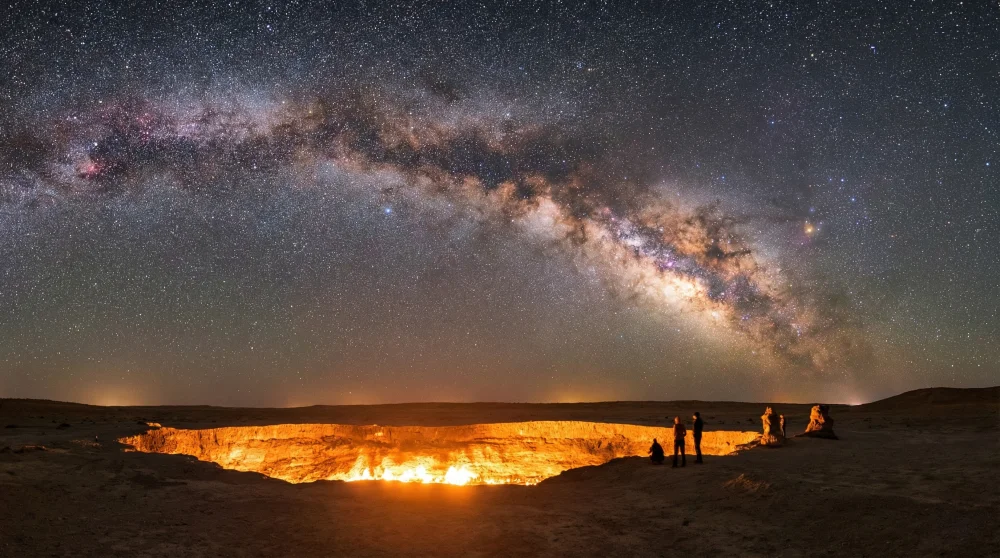 Long exposure shot of the Milky Way galaxy over the glowing rim of the Darvaza Gas Crater
