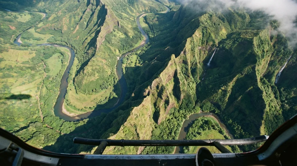 Aerial view of Kauai's rugged Hanapepe Valley from a doors-off helicopter flight