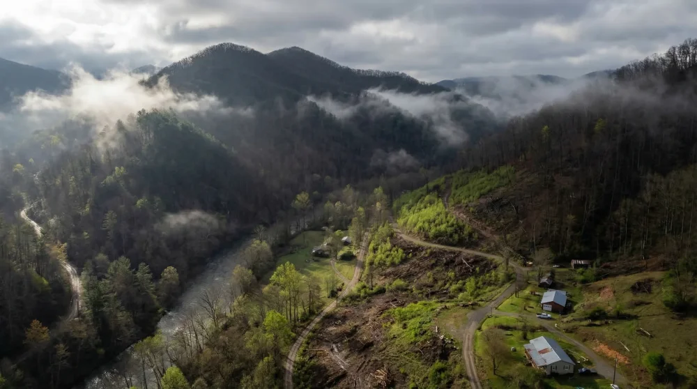 Aerial view of North Carolina mountain valley showing natural recovery and misty peaks