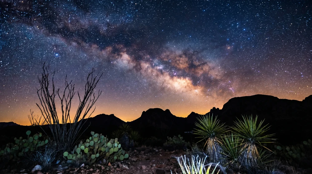 Stunning view of the Milky Way galaxy over the dark desert landscape of Big Bend National Park.