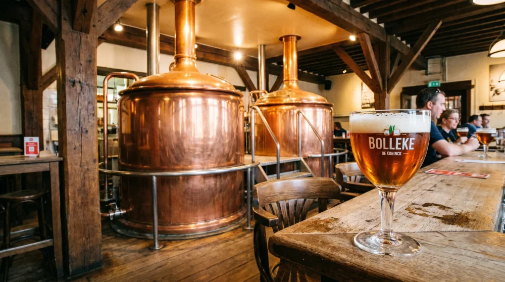 Copper brewing vats and a glass of local beer at the De Koninck Brewery in Antwerp
