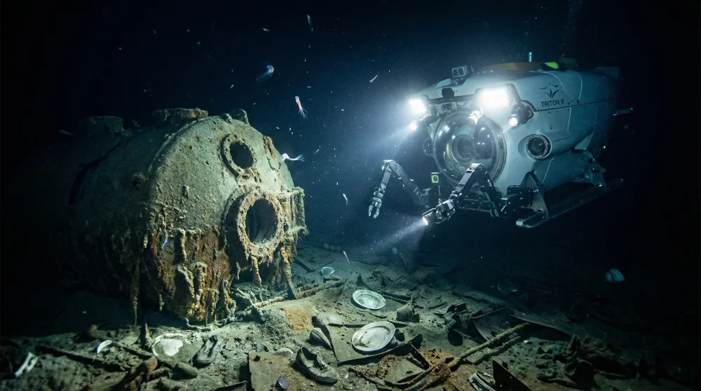 Underwater submersible lights illuminating a boiler in the Titanic debris field 12,500 feet deep