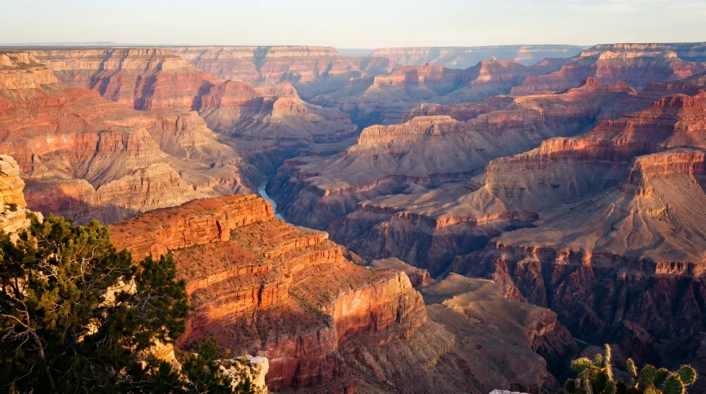Detailed layers of the Grand Canyon during sunset showing rich red and orange hues and immense depth
