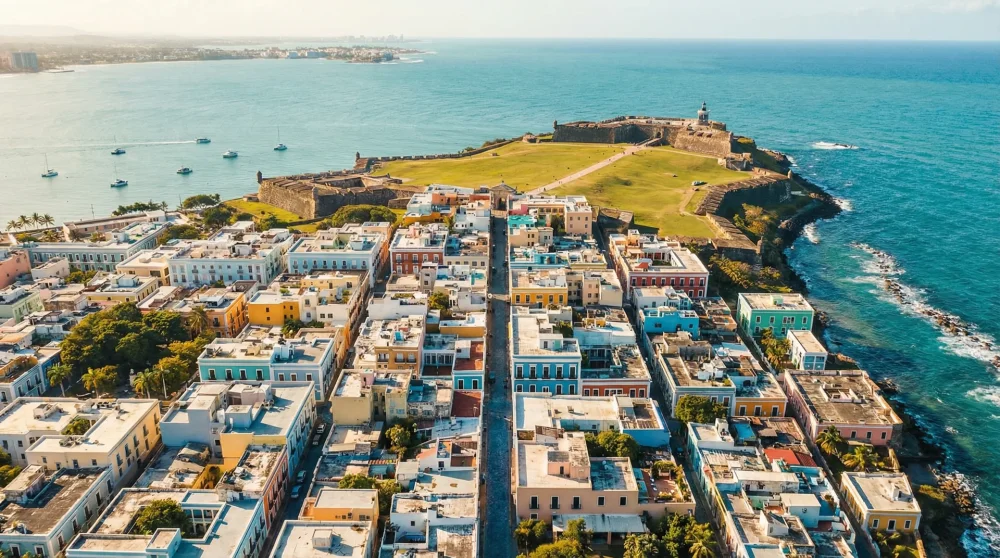 Aerial view of colorful colonial buildings and historic fortress in Old San Juan Puerto Rico next to the ocean