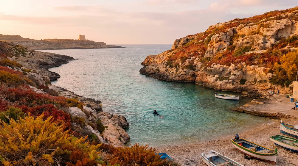 Swimmer enjoying a calm autumn dip in warm Gozo coastal water