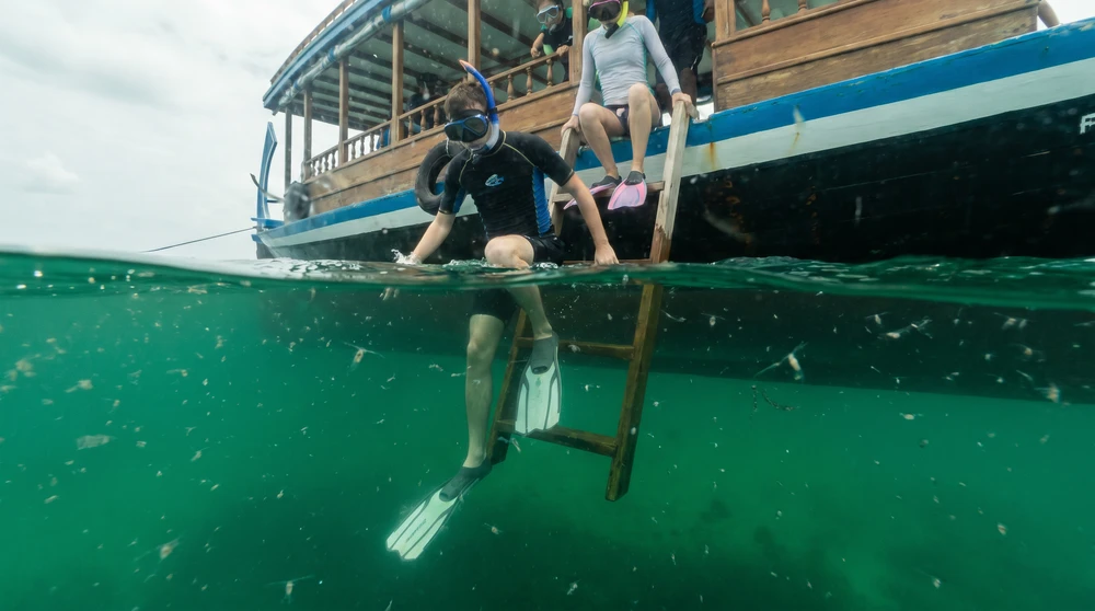 Snorkelers entering plankton-rich water from a dhoni near Hanifaru Bay in the Maldives