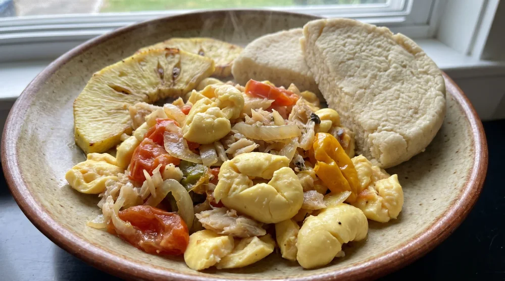 Plate of Jamaican ackee and saltfish served with roasted breadfruit - Jamaica's national dish