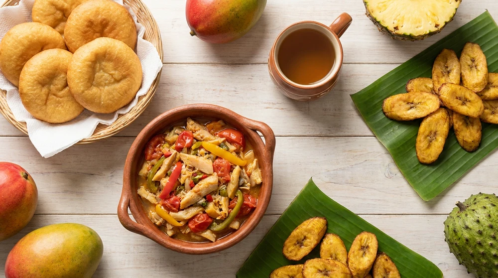 Traditional Kittitian breakfast spread of johnny cakes saltfish and fried plantains