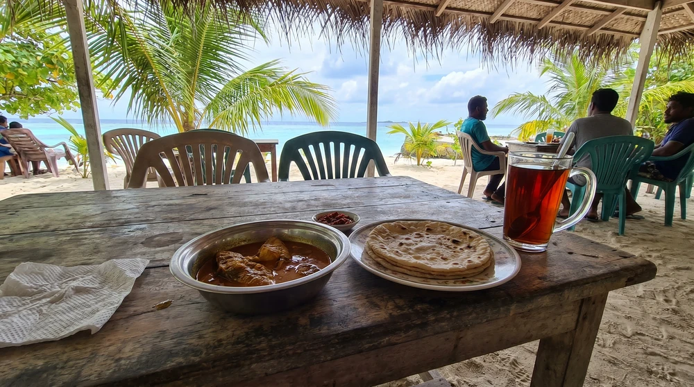 Simple local island cafe meal of curry, flatbread and tea in the Maldives