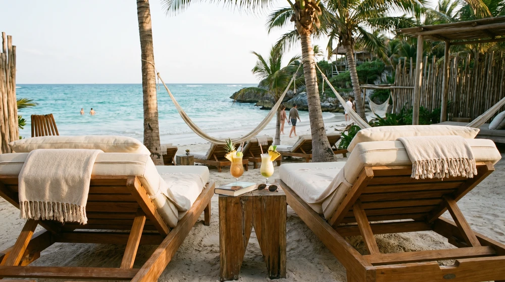 Relaxed private resort beach with loungers and cocktails in the Maldives