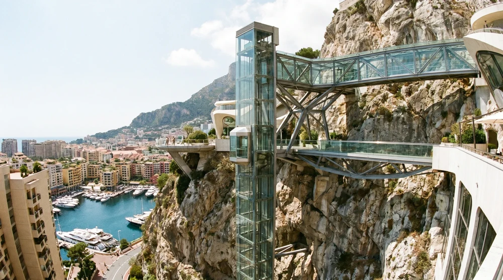 Free public glass lift built into the rock face connecting Monaco harbor to upper neighborhoods