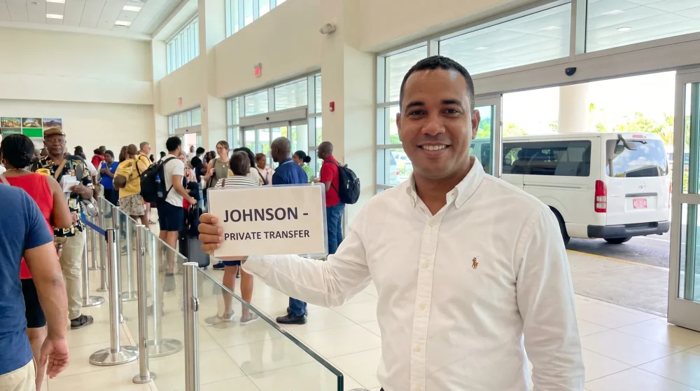 Pre-booked transfer driver holding a name sign at Sangster International Airport in Montego Bay Jamaica