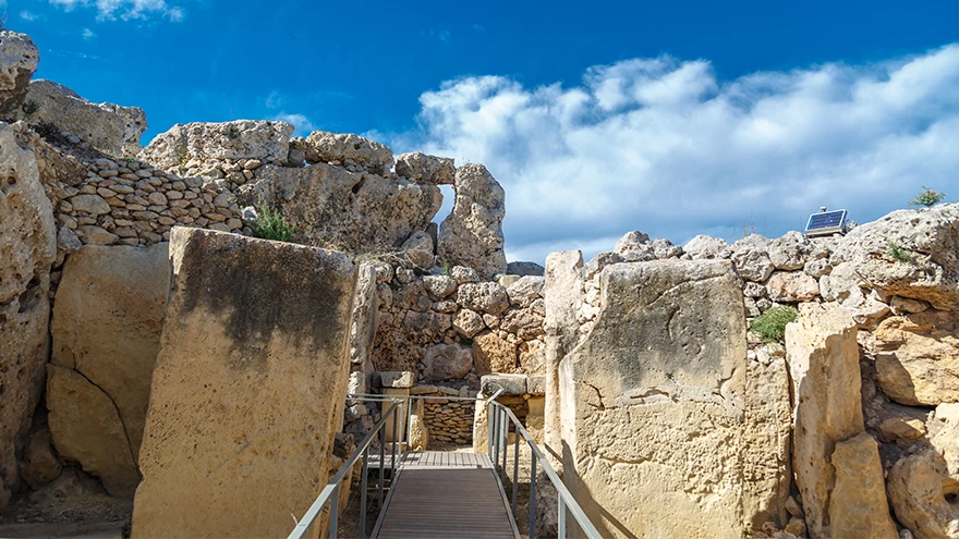 Wooden visitor walkway leading between the upright megaliths into the Ggantija temple entrance in Gozo