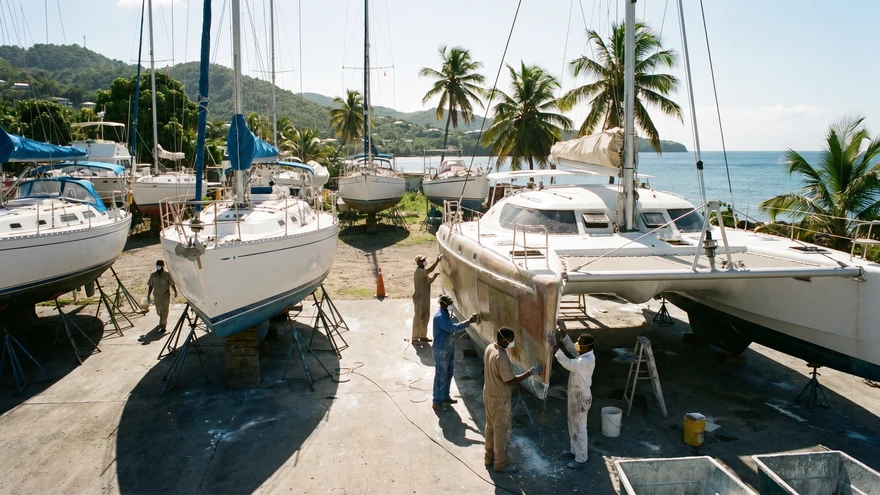 Sailors preparing yachts for storage at Grenada boatyard during hurricane season