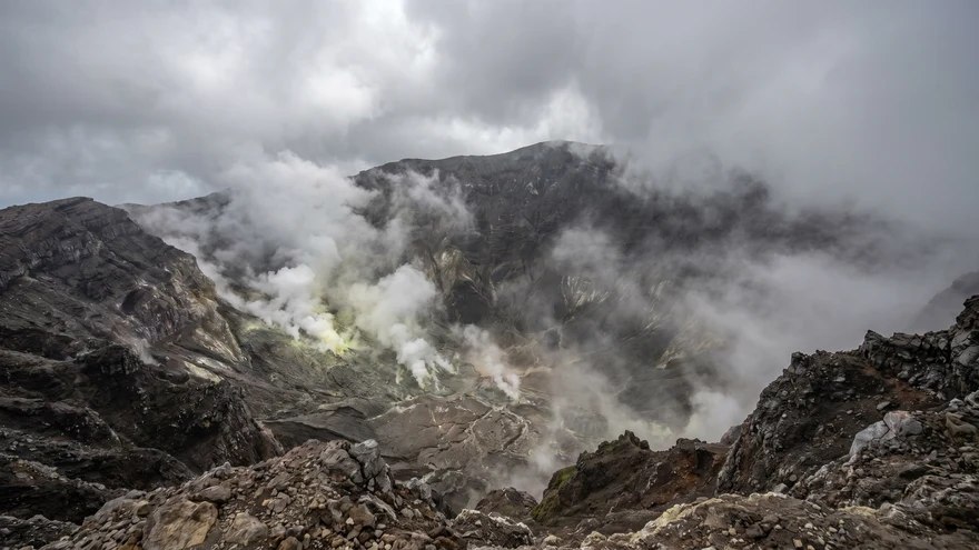 La Soufriere volcano crater with steam fumaroles rising from the abyss and dramatic clouds at summit St Vincent
