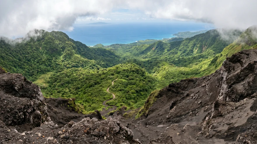 Panoramic view from La Soufriere Windward Trail looking down over St Vincent rainforest and Caribbean coastline with Bequia on horizon