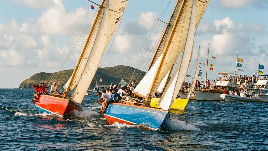 Traditional wooden racing sloops heel sharply in a stiff trade wind off