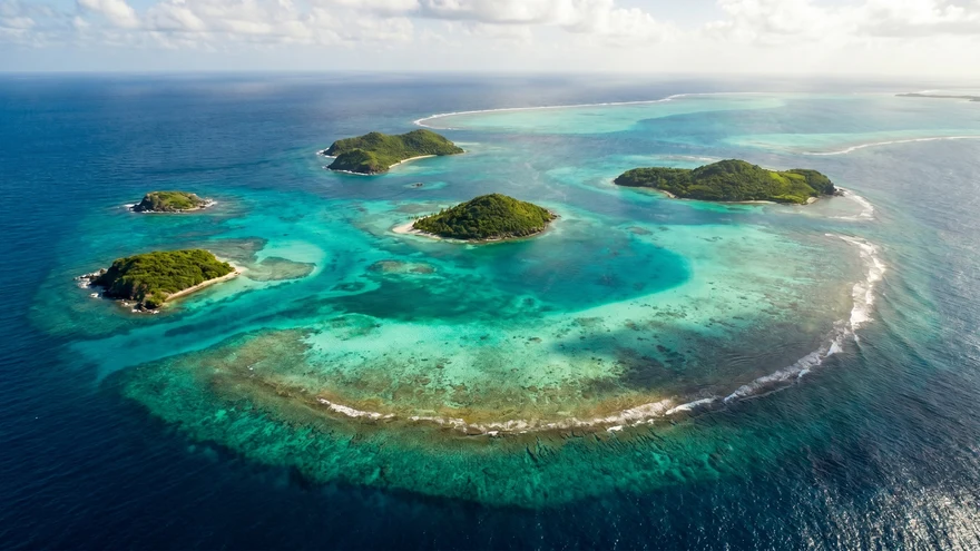 Aerial view of Tobago Cays five uninhabited islands surrounded by turquoise lagoon with Horseshoe Reef visible