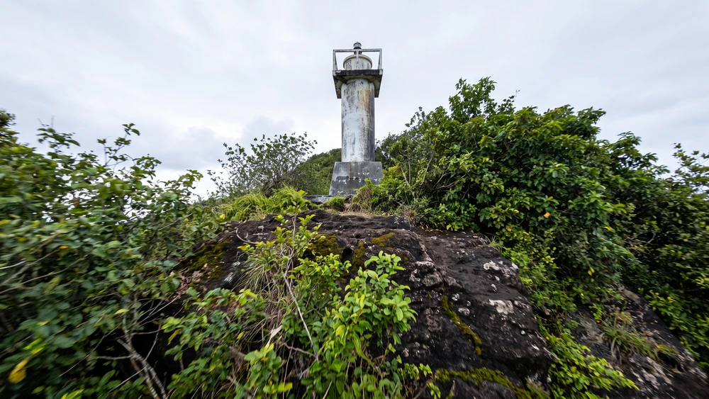 Small lighthouse on Apolima Island's crater rim overlooking the village and ocean