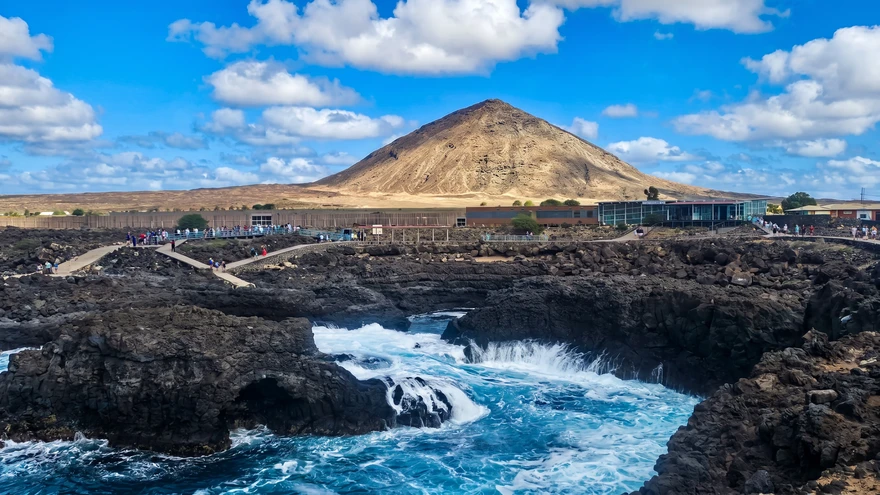 Wooden boardwalk and viewing platform overlooking the Buracona lava coastline on Sal