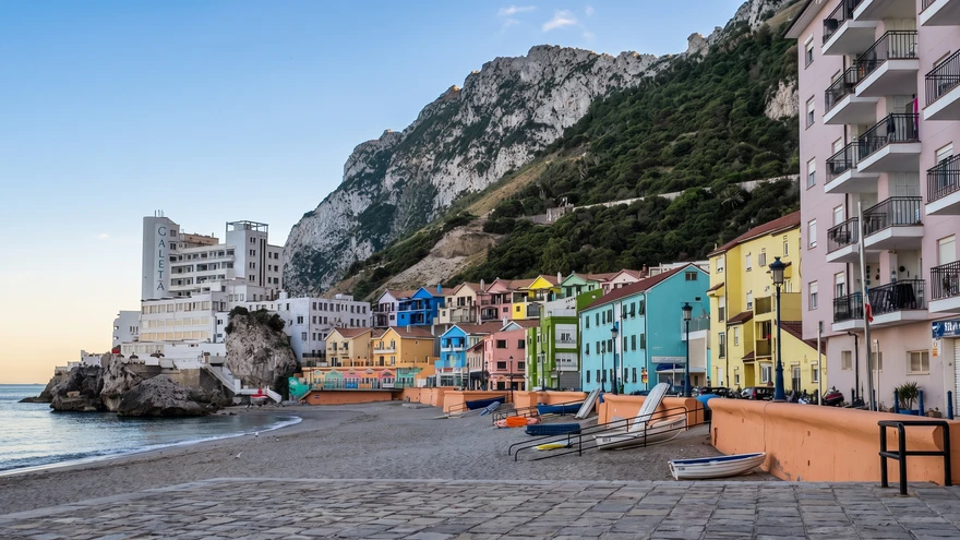 Catalan Bay seafront promenade with colorful buildings at dusk
