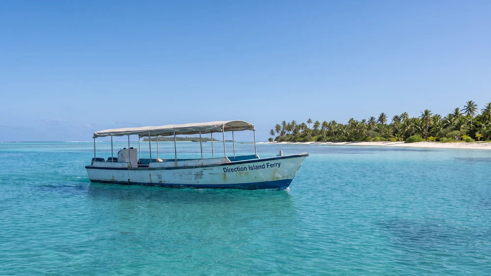 Small ferry boat crossing the lagoon toward Direction Island in the Cocos Islands