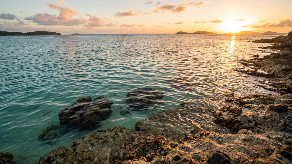 Melones Beach in Culebra at golden hour with coral heads visible near the shore