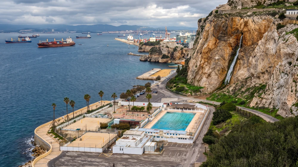 Aerial view of the Europa Waterfall desalination discharge cascading down the cliffs above the coastal road