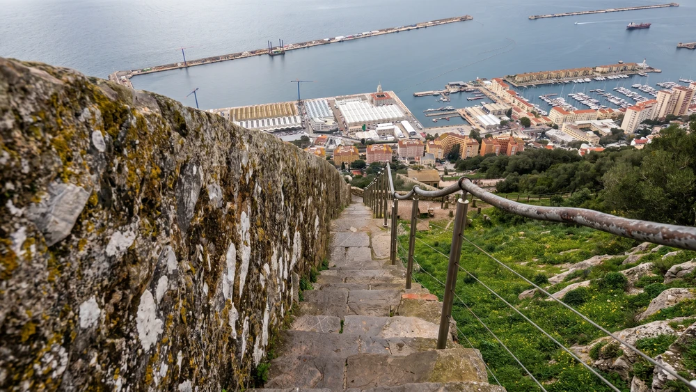The steep Charles V Wall staircase descending toward Gibraltar's harbor and marina