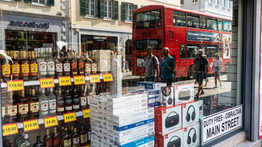 Duty-free shop window displaying spirits, tobacco, and electronics in Gibraltar