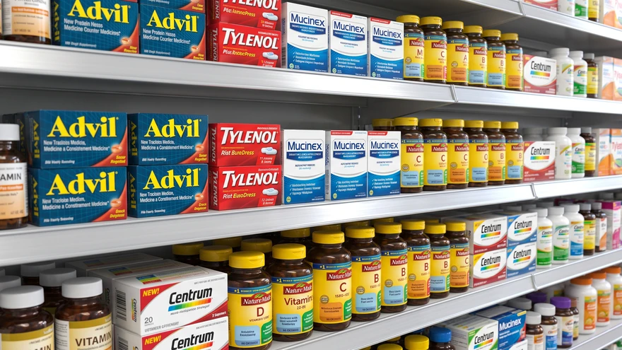 Pharmacy shelf stocked with over-the-counter medicine and vitamins in Gibraltar