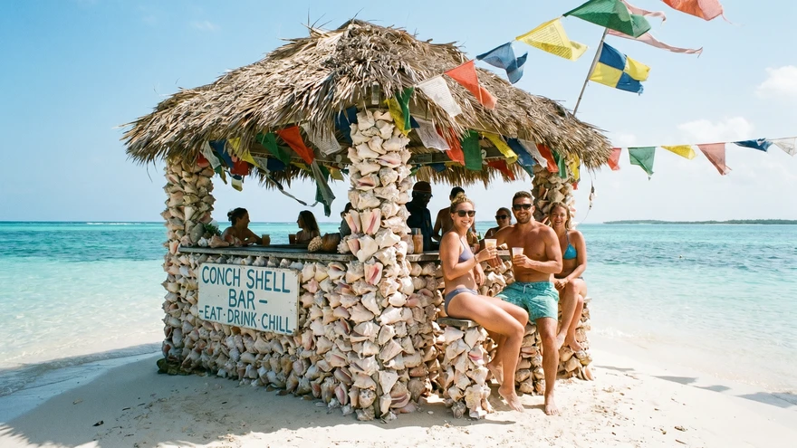 Small bar built from stacked conch shells on a sandbar in the Grenadines