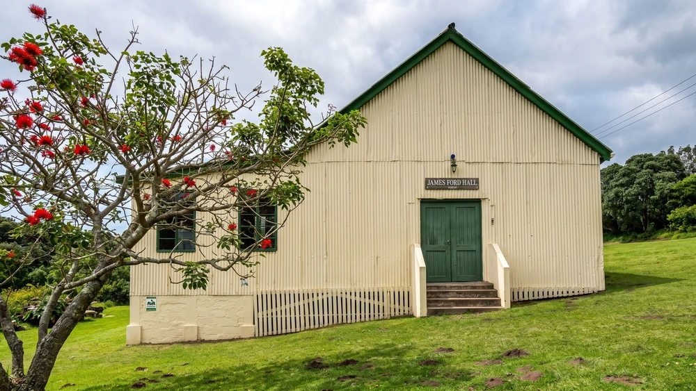 The historic 1925 James Ford Hall with its weathered facade and wooden steps in Kasouga