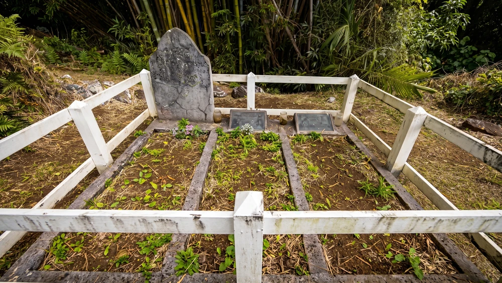 John Adams grave site fenced with white railing on Pitcairn Island