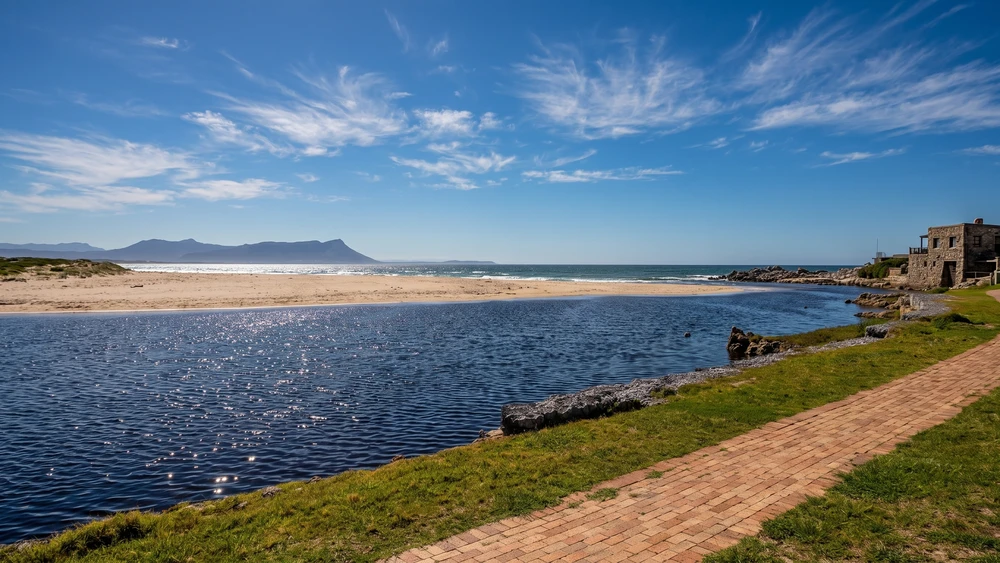 Calm Kleinmond lagoon with the beach and distant mountains