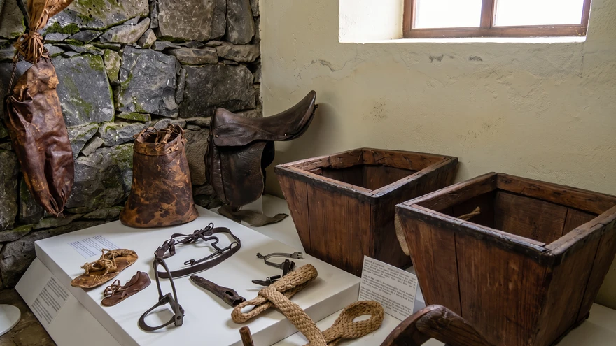 Display of traditional leather saddles and farming tools at the Museu Etnografico da Praia