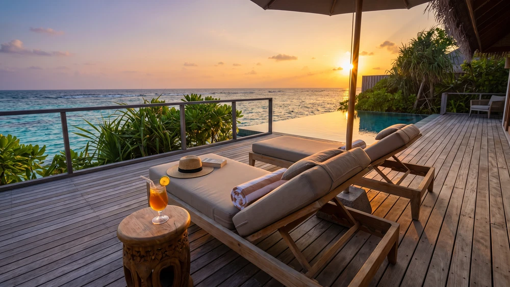 Luxury oceanfront villa deck overlooking the reef at sunset
