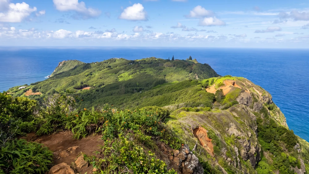 View from the Highest Point on Pitcairn Island overlooking the green ridge and ocean