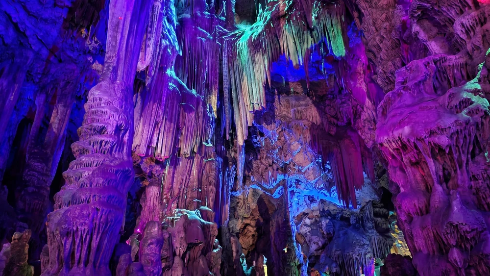 Stalactite formations inside Saint Michael's Cave lit in purple tones during the light show
