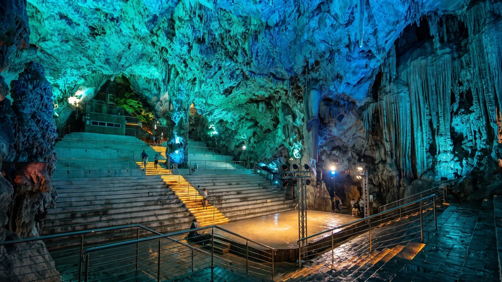 The Cathedral Cave inside Saint Michael's Cave lit in turquoise tones during the Awakening light show