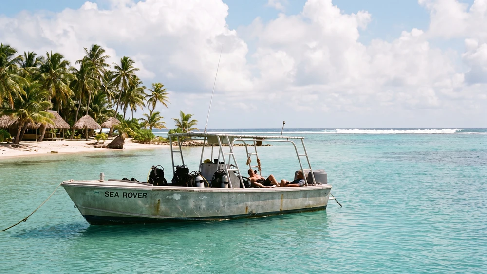 Dive boat sheltering in the calm inner lagoon during windy season