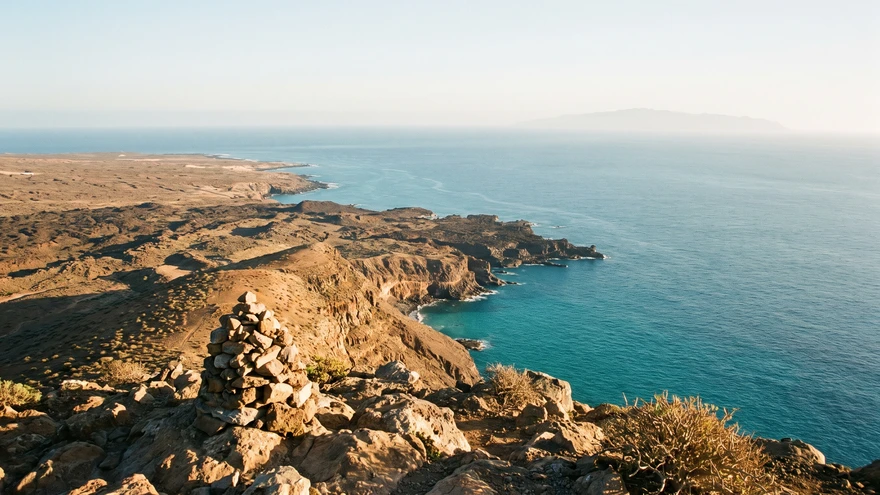 Panoramic summit view over Sal Island's southern coastline with a distant island on the horizon