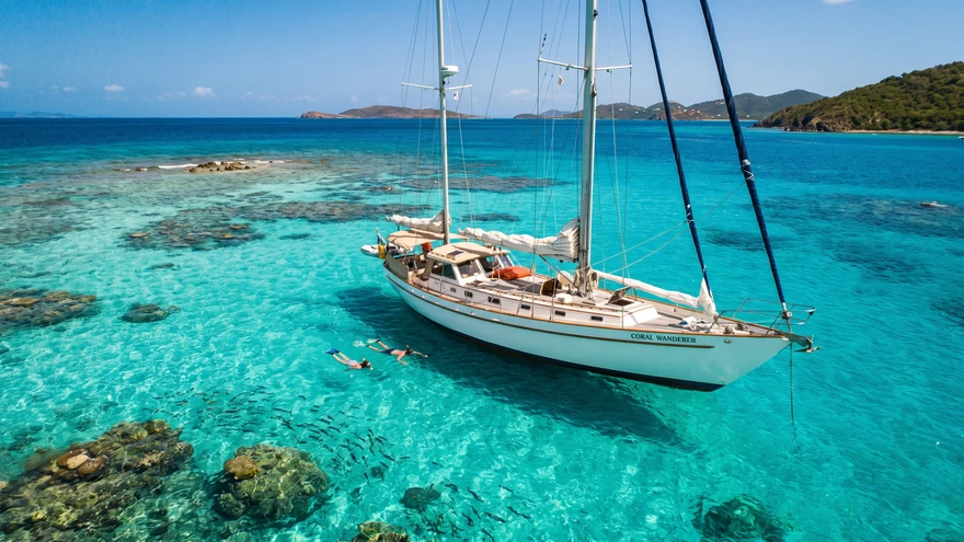Sailing yacht anchored in clear turquoise water during the dry season boating conditions in the Grenadines